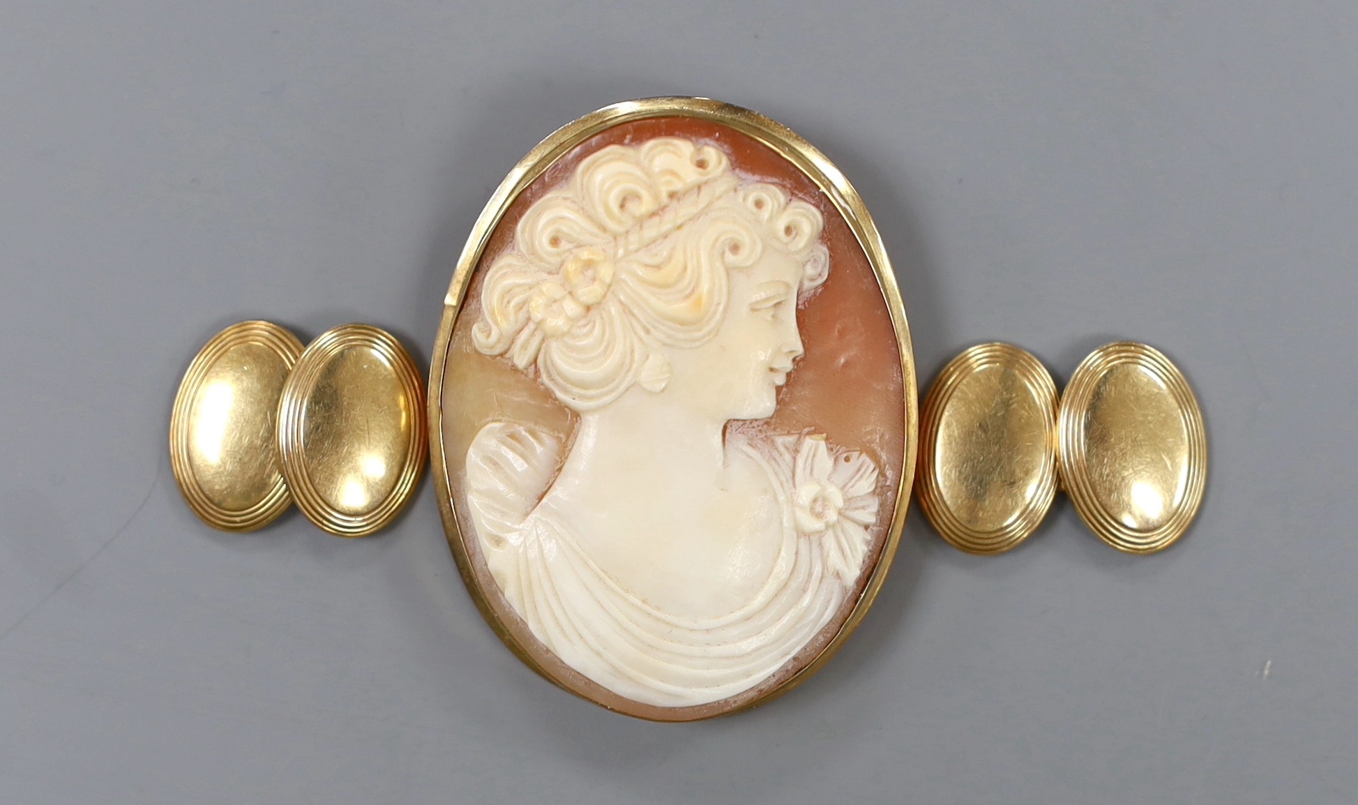 A pair of yellow metal oval cufflinks, 4.1 grams and an Italian 9k mounted oval cameo shell brooch.